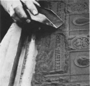 Filling the deep relief pattern plate with Bakelite powder